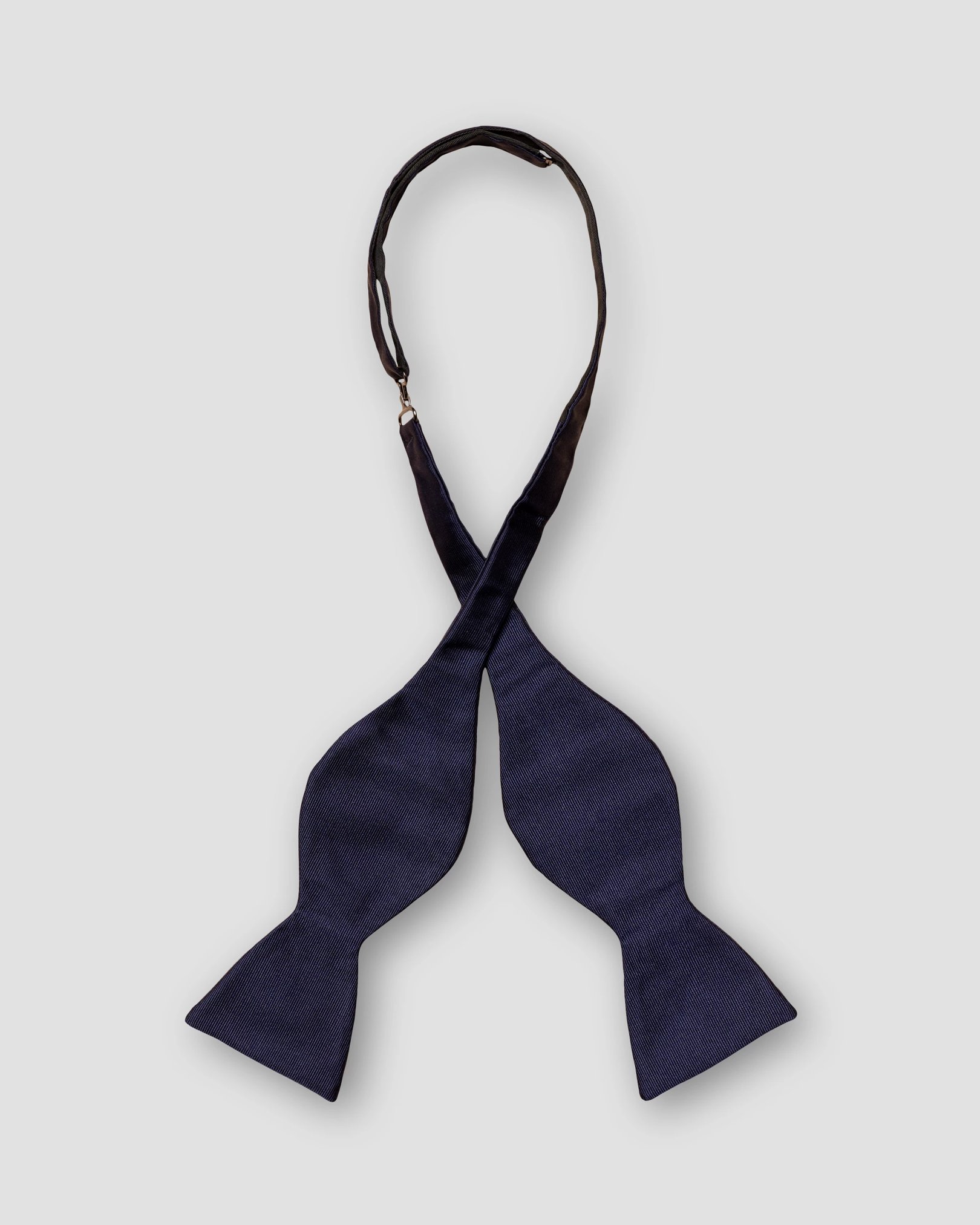 Eton - dark blue bow tie self tied dressed