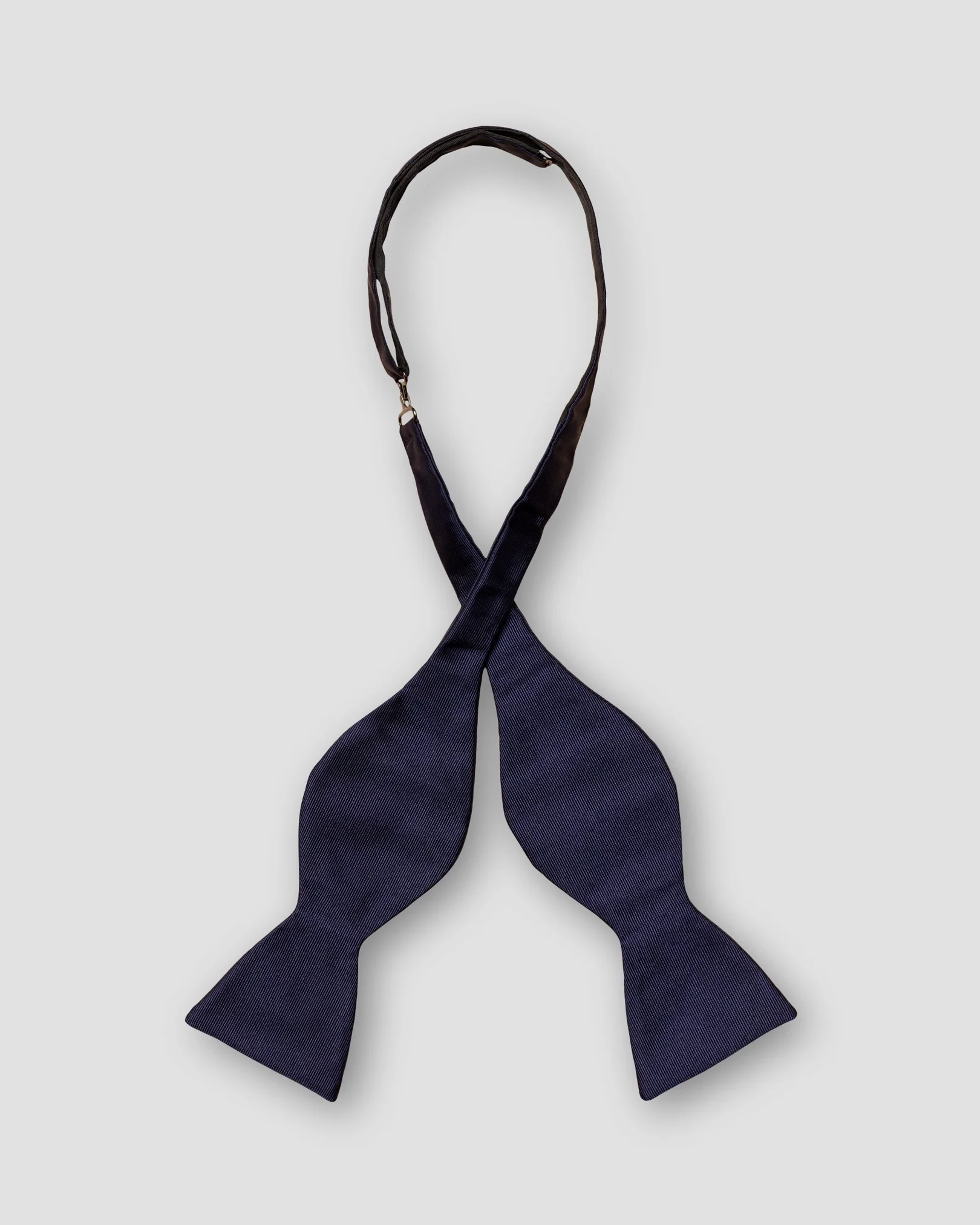 Eton - dark blue bow tie self tied dressed